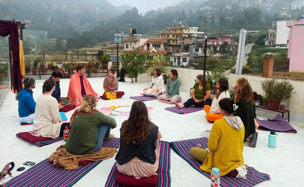 Guests practising rooftop yoga and meditation at Niru Yoga Homestay in Nepal