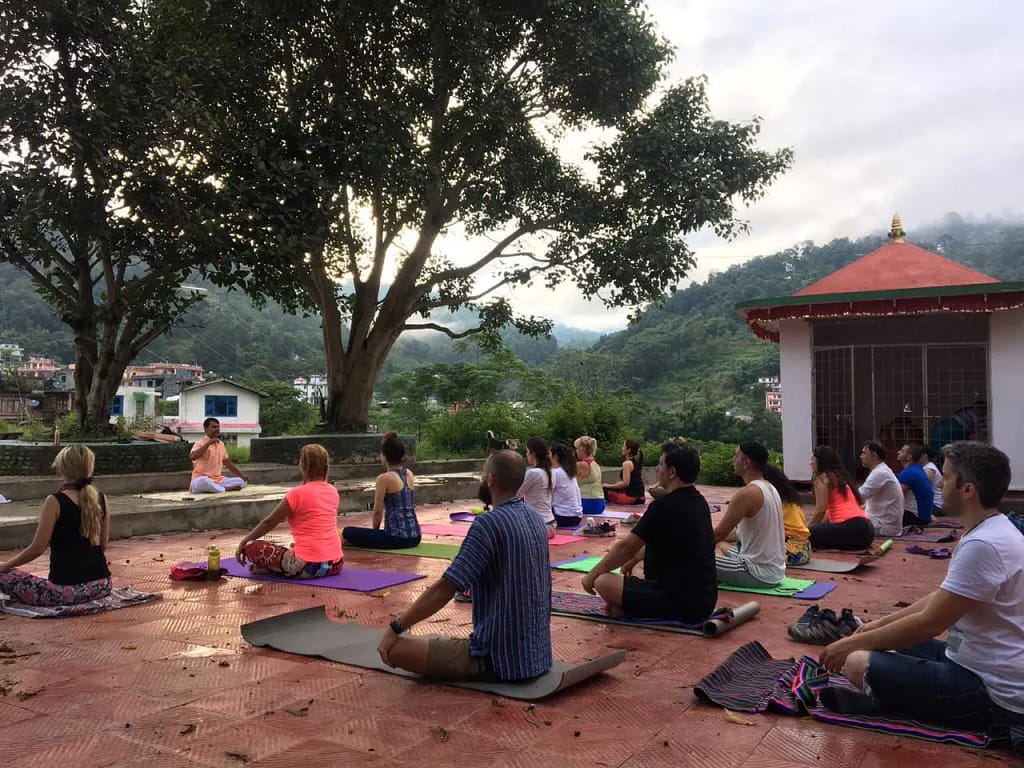 Guests practising outdoor yoga, pranayama and meditation at a retreat in Nepal