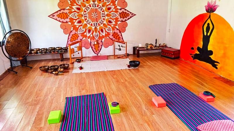 Yoga hall at Niru Yoga Homestay with mats and singing bowls