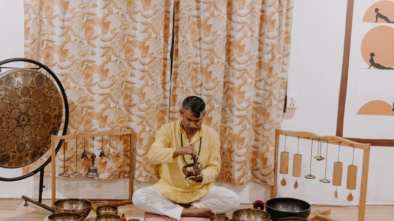 Sound healing teacher conducting a singing bowl session at a yoga retreat in Nepal