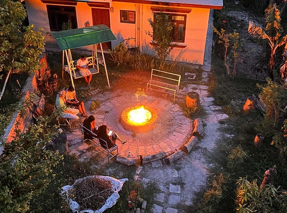 Evening campfire and relaxation activities at yoga retreat in Nepal